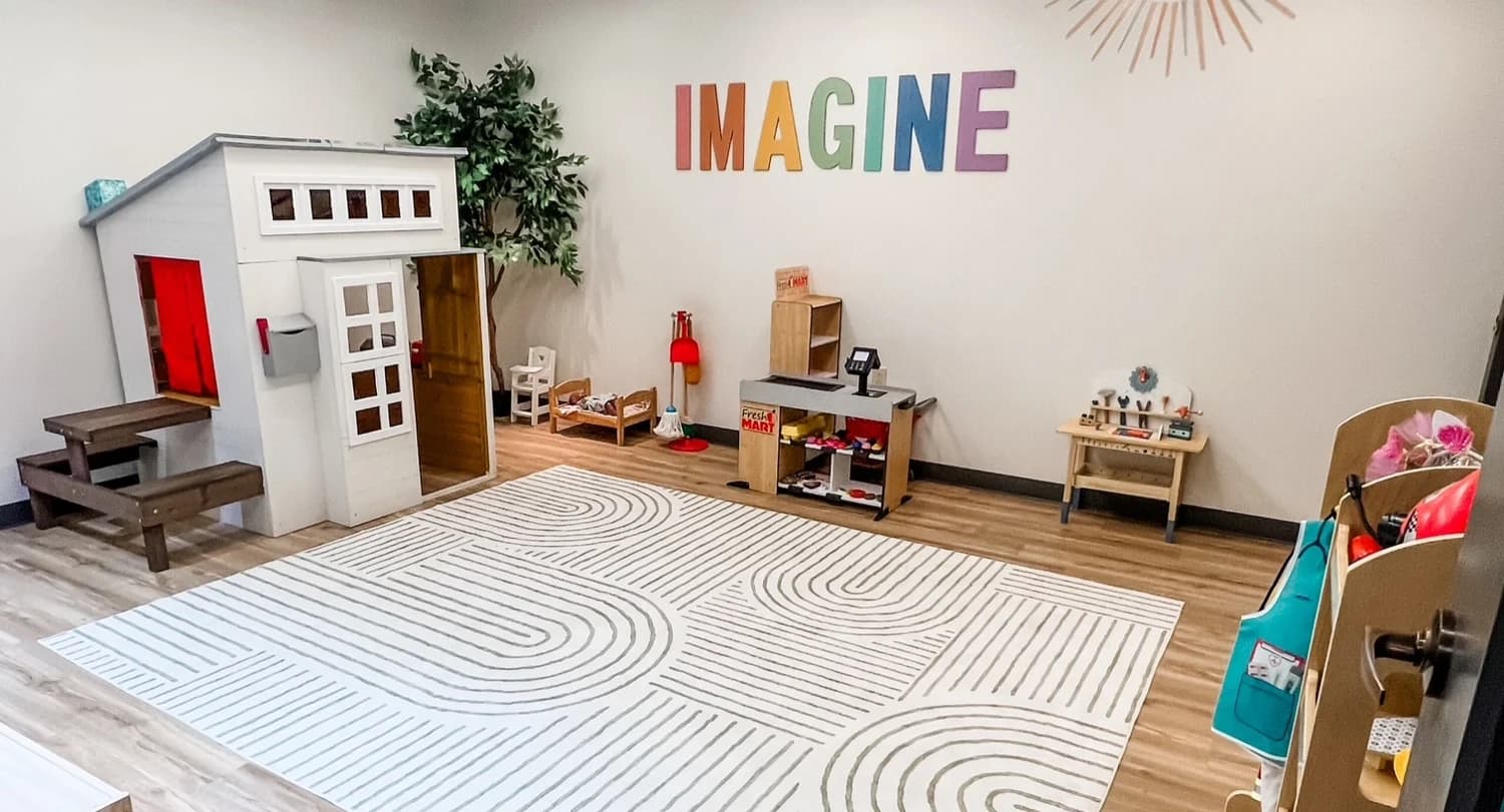 A play kitchen and dollhouse in a Latitude learning space