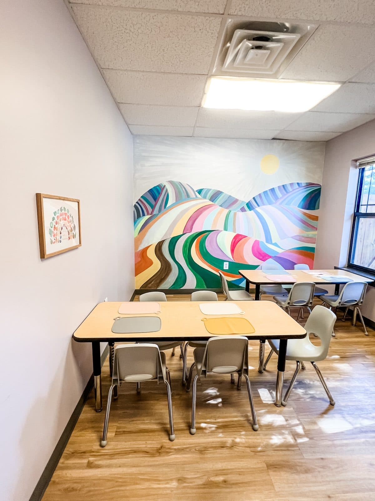 Lunch room with child-sized tables and a wall mural at Latitude's Bridgeton ABA center