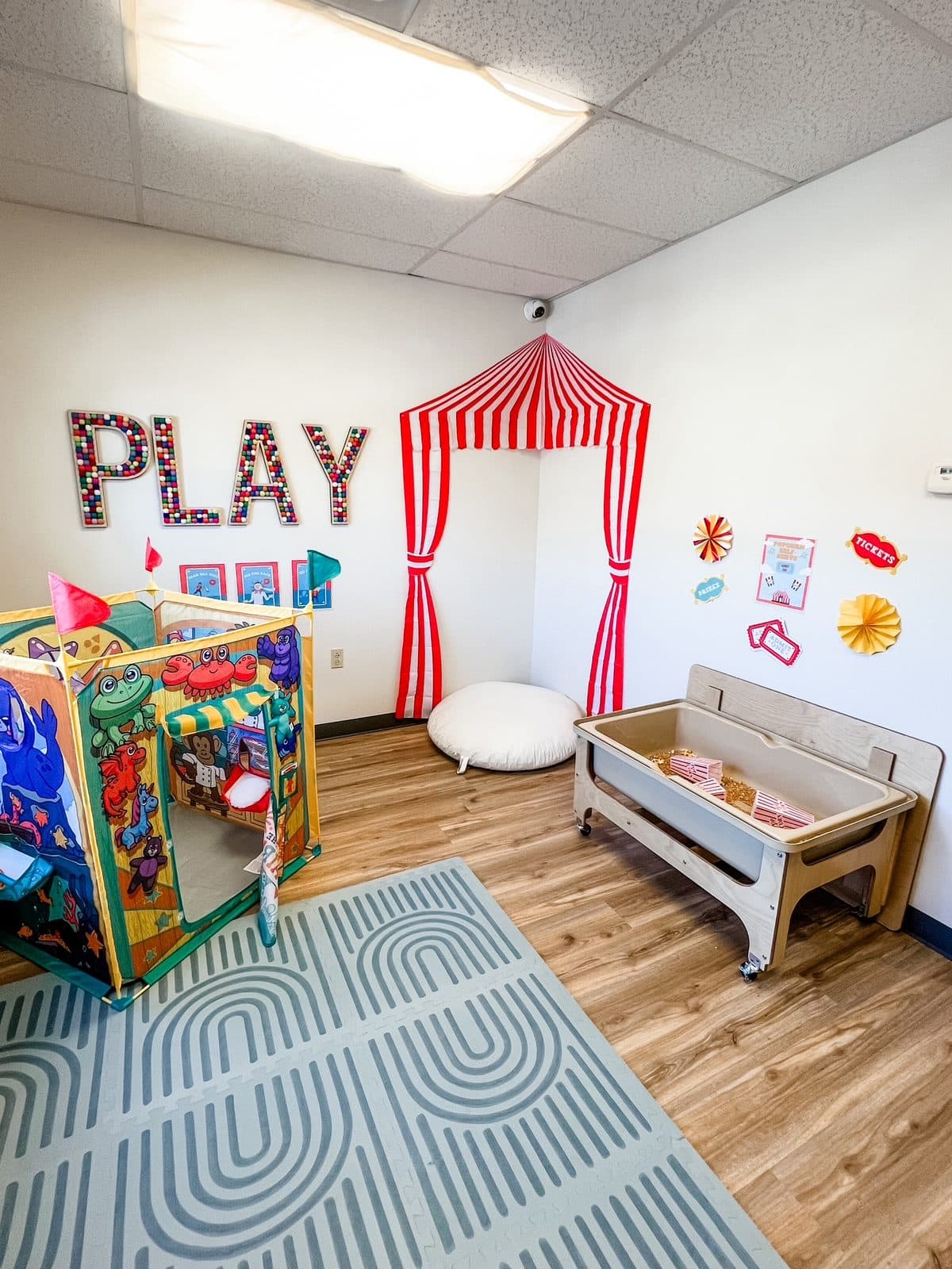 Striped reading tent and activity cube in the play room at Latitude's Bridgeton ABA center