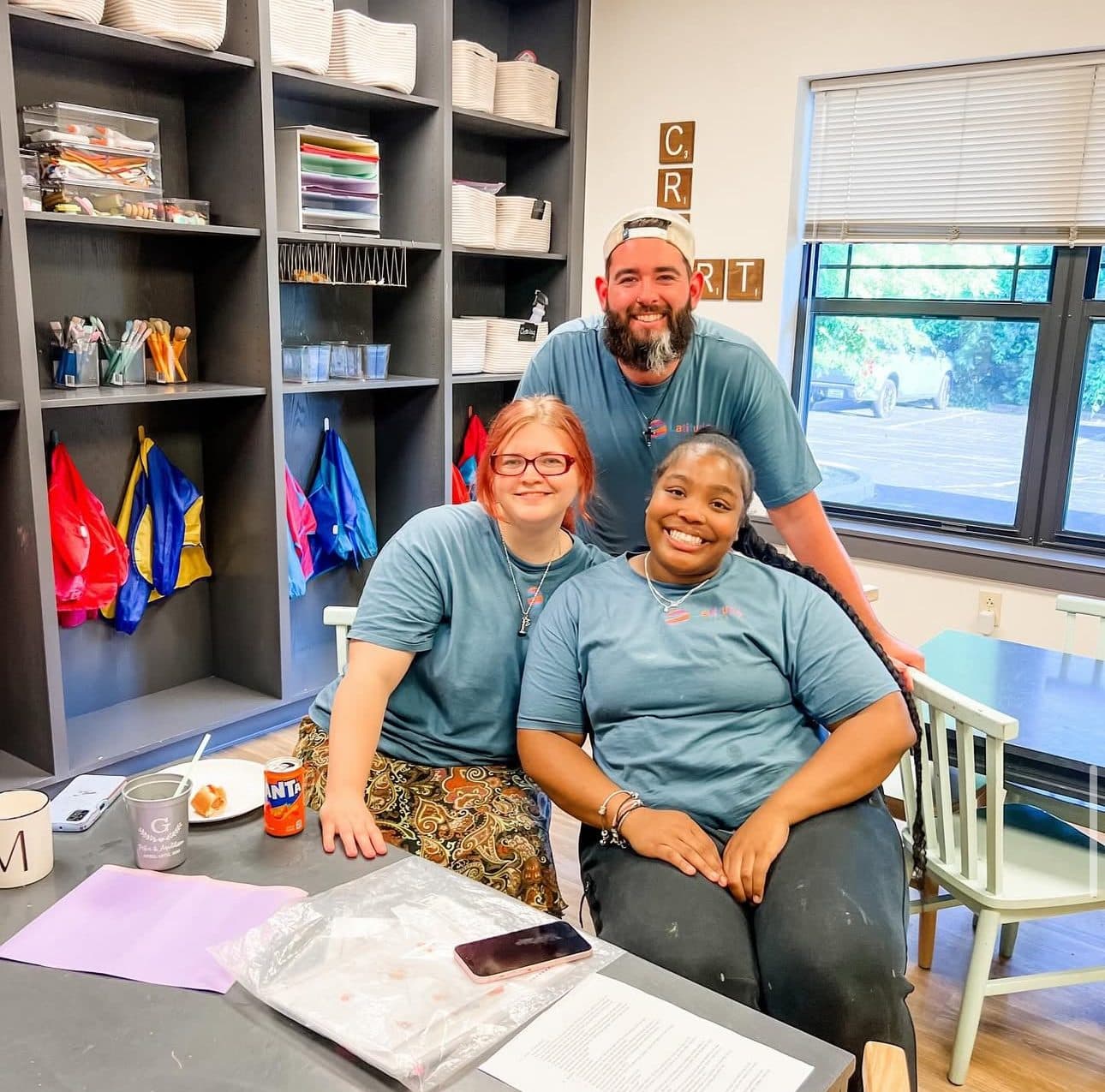 Three Latitude Therapy team members in the art room