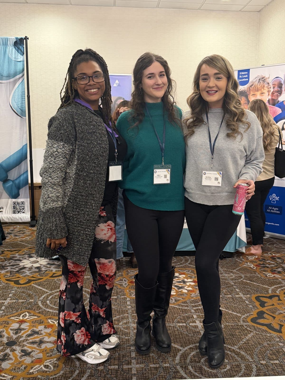 Three Latitude Therapy team members at an indoor event