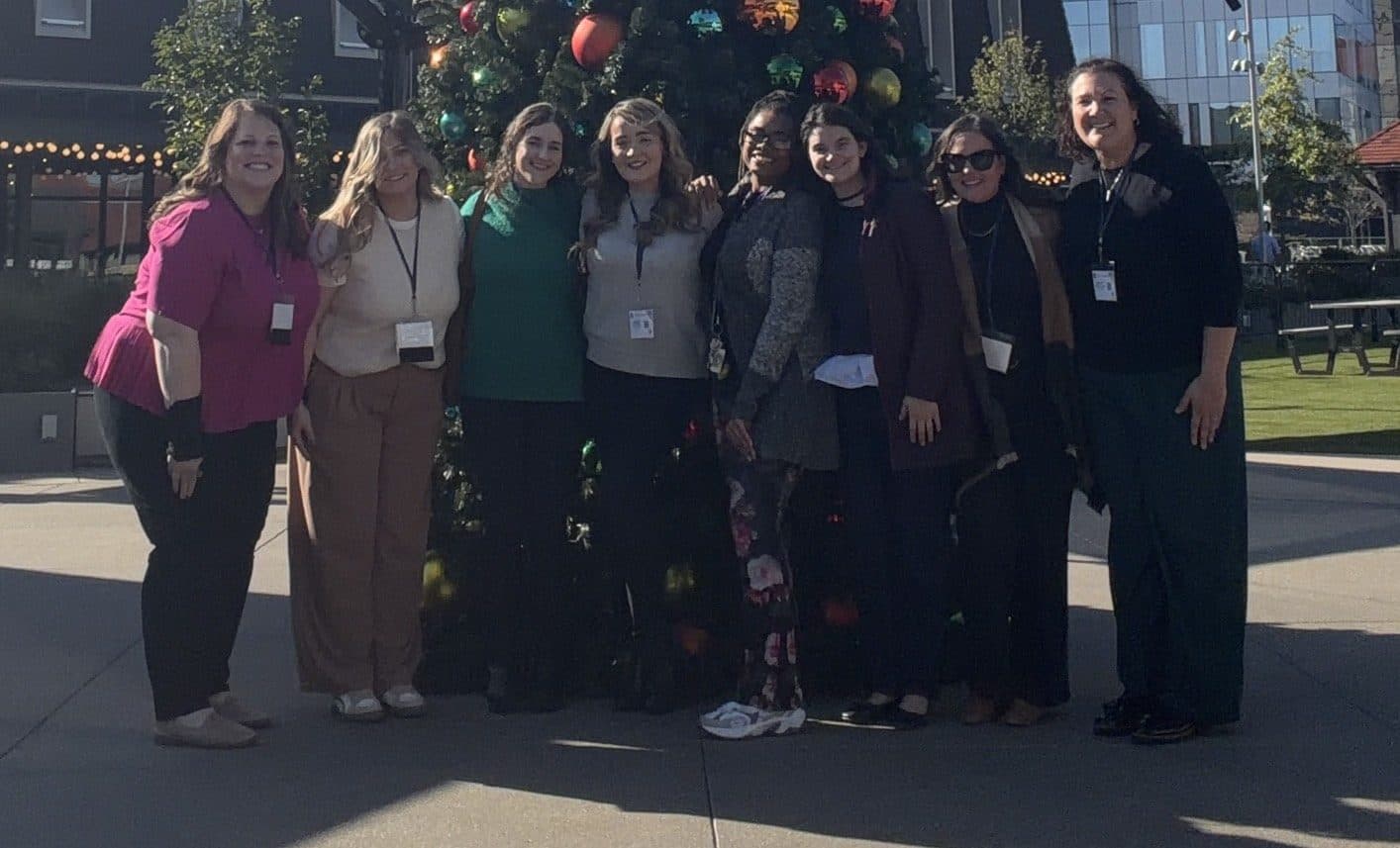 Latitude Therapy team members outdoors in front of a holiday tree