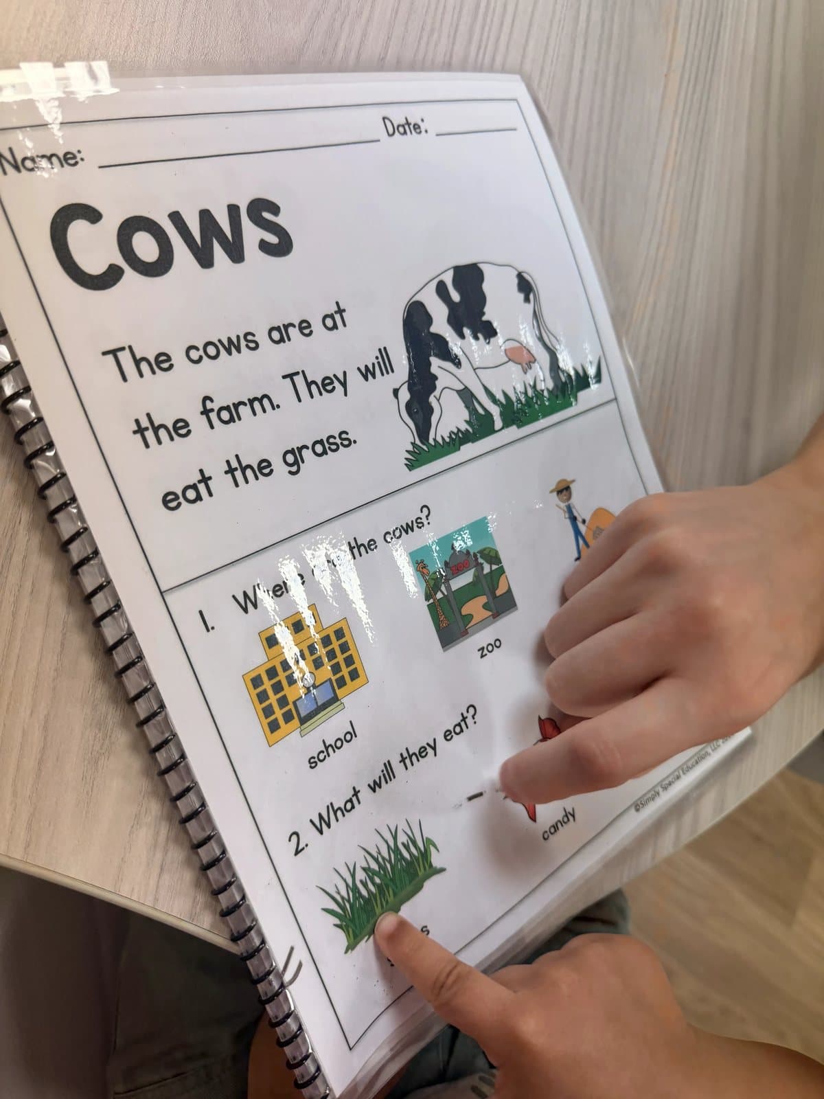 A reading page about cows with picture symbols during Farm week at Latitude's St. Peters center