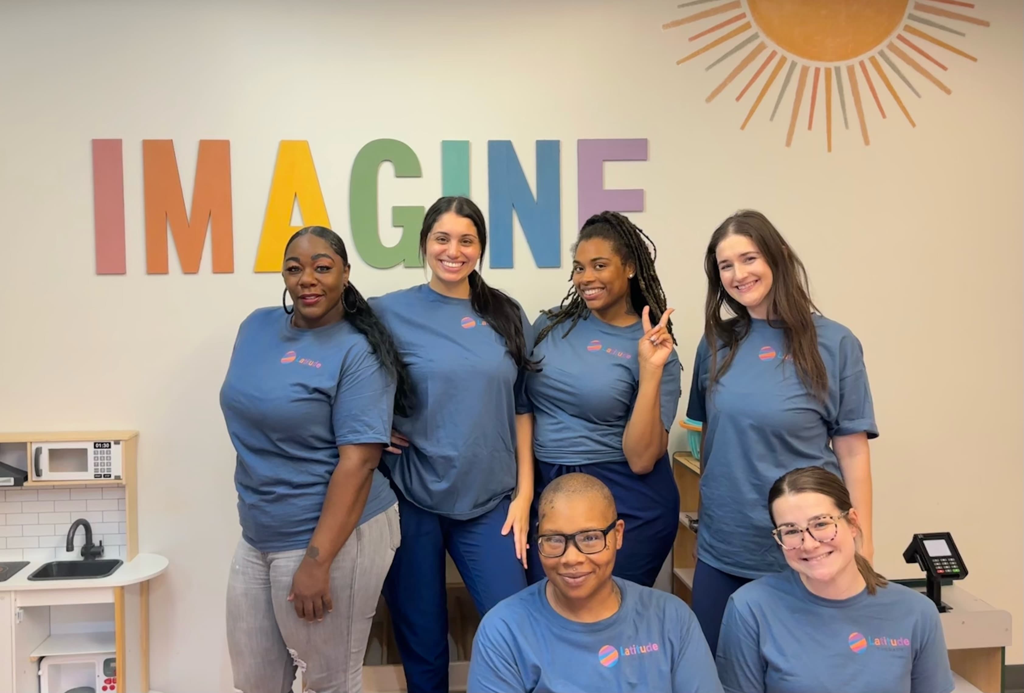 Latitude team members together in a learning space